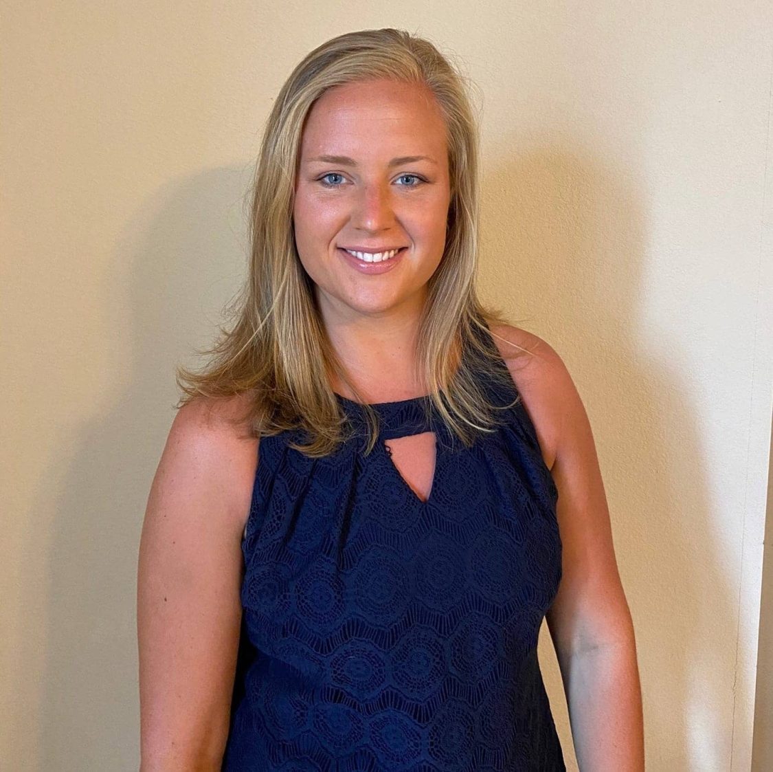 Lady smiling in Navy blue dress shirt