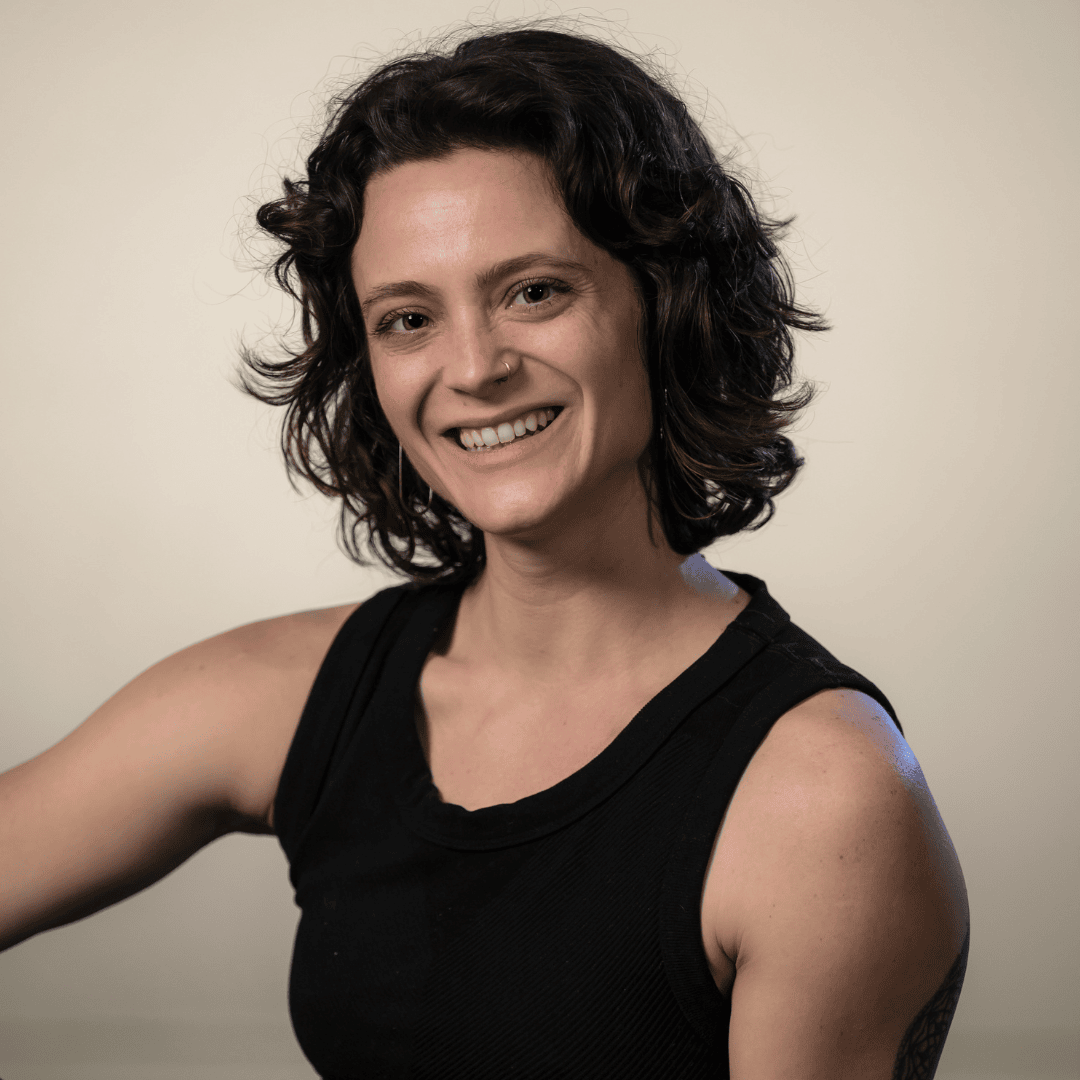 female smiling with dark hair and tank top