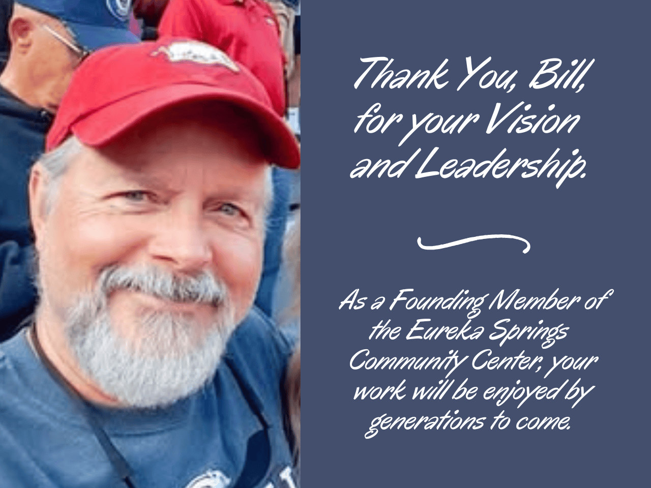 older man with white beard smiling wearing a red ballcap