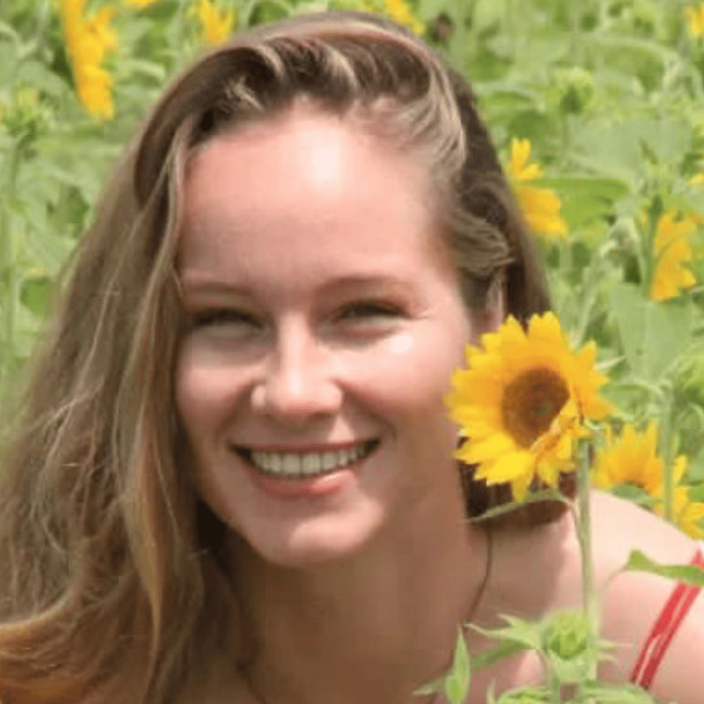 Smiling woman in field of flowers