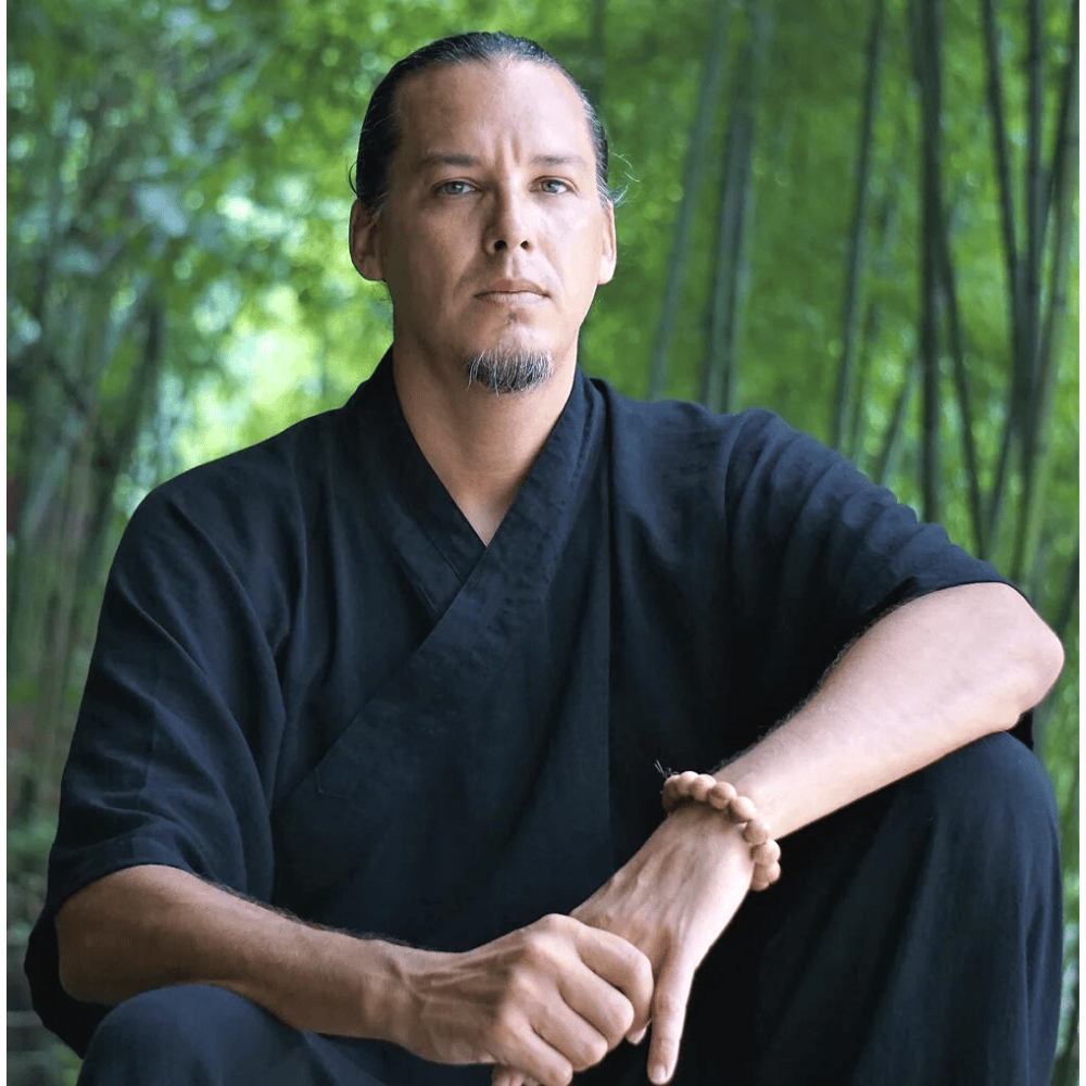 Man sitting in forest, tai chi teacher